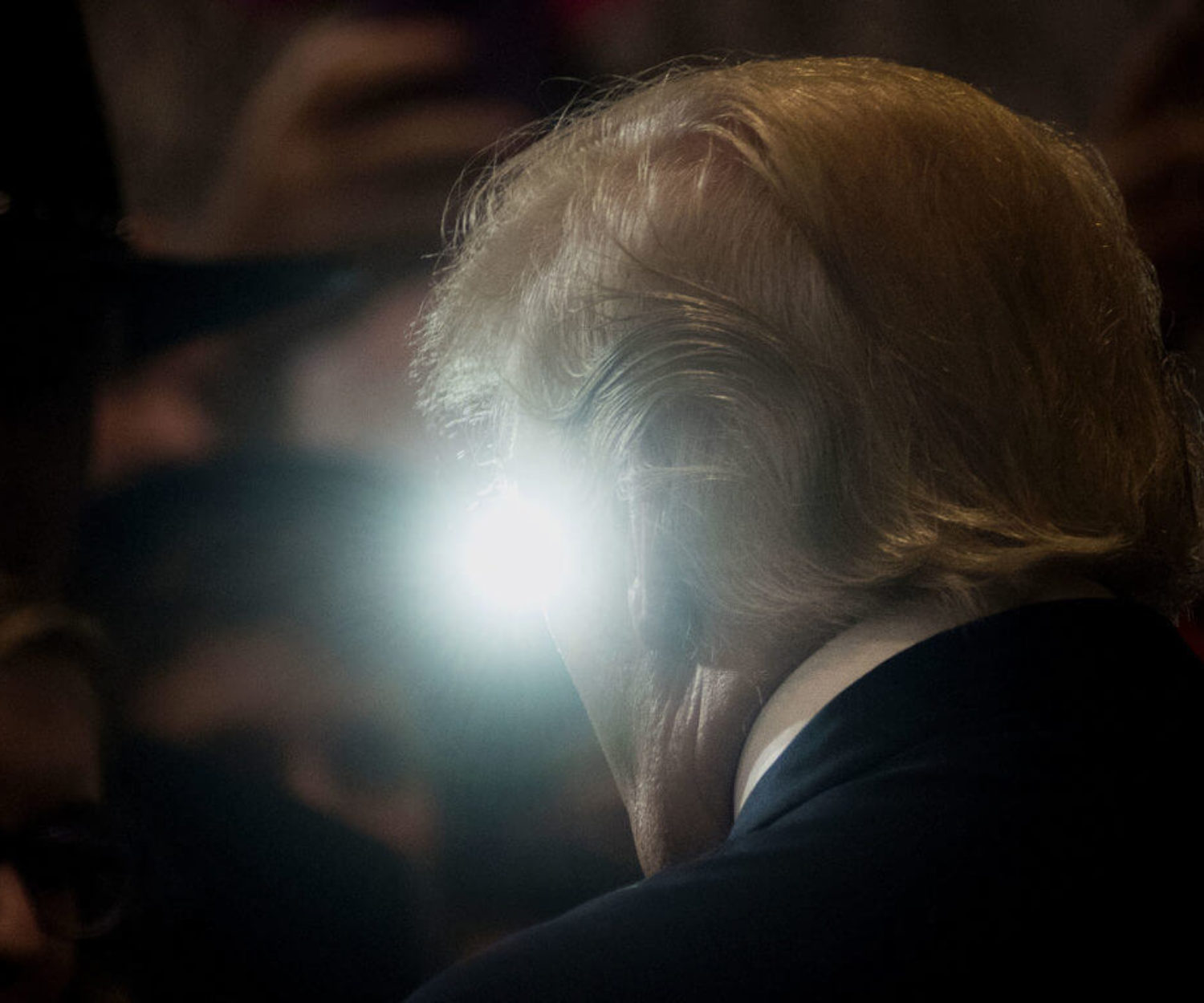A light from the crowd is seen past Donald Trump, 2016 Republican presidential nominee, during a goodbye reception at the Westin Hotel in Cleveland, Ohio, U.S., on Friday, July 22, 2016. A day after accepting the Republican presidential nomination in a speech that signaled a more serious turn heading into the general election, Trump ripped into former primary competitor Ted Cruz, revisiting their ugly feud over Cruzs wife and father. Photographer: Ty Wright/Bloomberg via Getty Images
