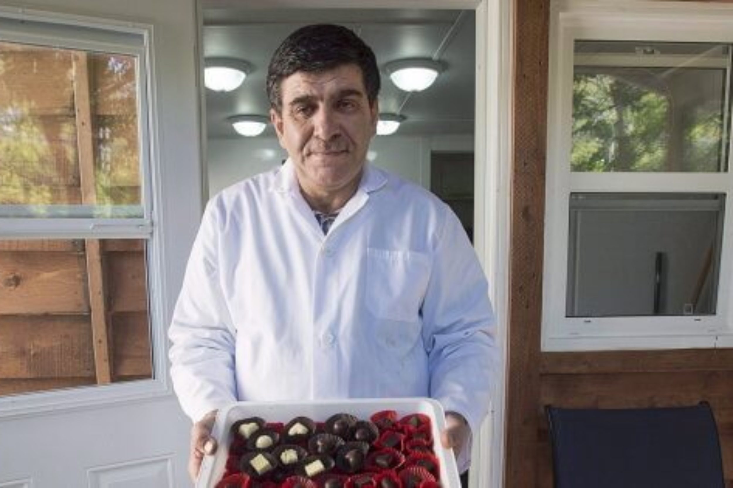 Assam Hadhad, a Syrian refugee who arrived in Canada last year, displays a tray of chocolates at his shop, Peace by Chocolate, in Antigonish, N.S. on September 21, 2016. The one-time Syrian refugee who founded a thriving Nova Scotia chocolate company has announced plans to hire and mentor other refugees. Peace by Chocolate of Antigonish, N.S., has committed to hiring 50 refugees by 2022, and to mentor 10 refugee-run start-ups over the next few years. THE CANADIAN PRESS/Andrew Vaughan